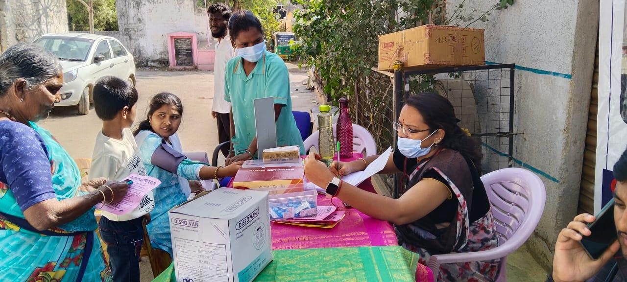 Doctor consulting patients at an Aaluri Hospital health camp